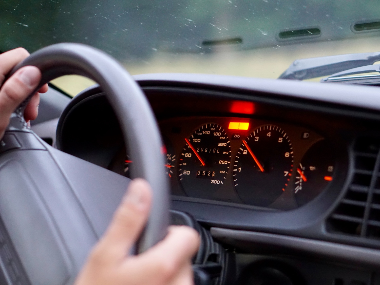 Driver with hands on steering wheel